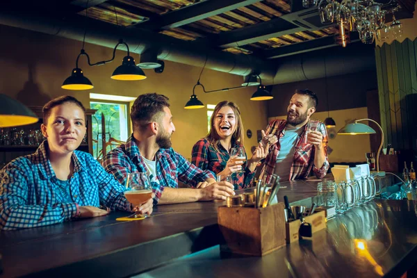 Sport, mensen, vrije tijd, vriendschap en entertainment concept - gelukkig voetbalfans of mannelijke vrienden drinken bier en vieren overwinning bij bar of pub — Stockfoto