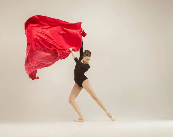 Modern ballet dancer dancing in full body on white studio background.