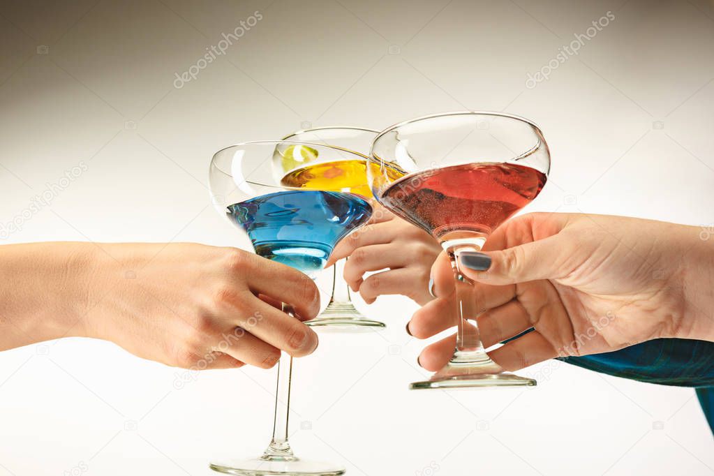 The male and female hands with exotic cocktails