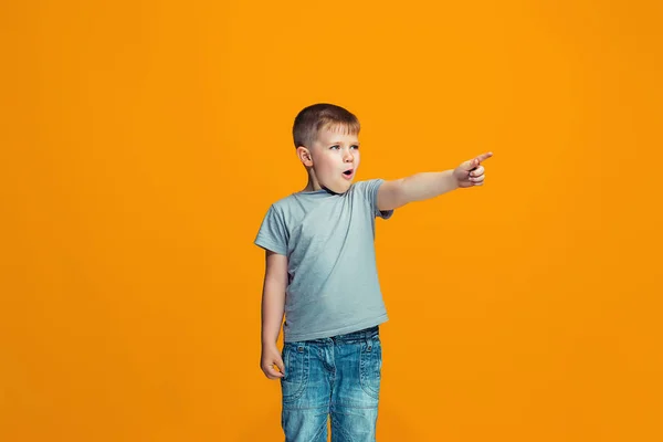 The happy teen boy pointing to you, half length closeup portrait on orange background. — Stock Photo, Image