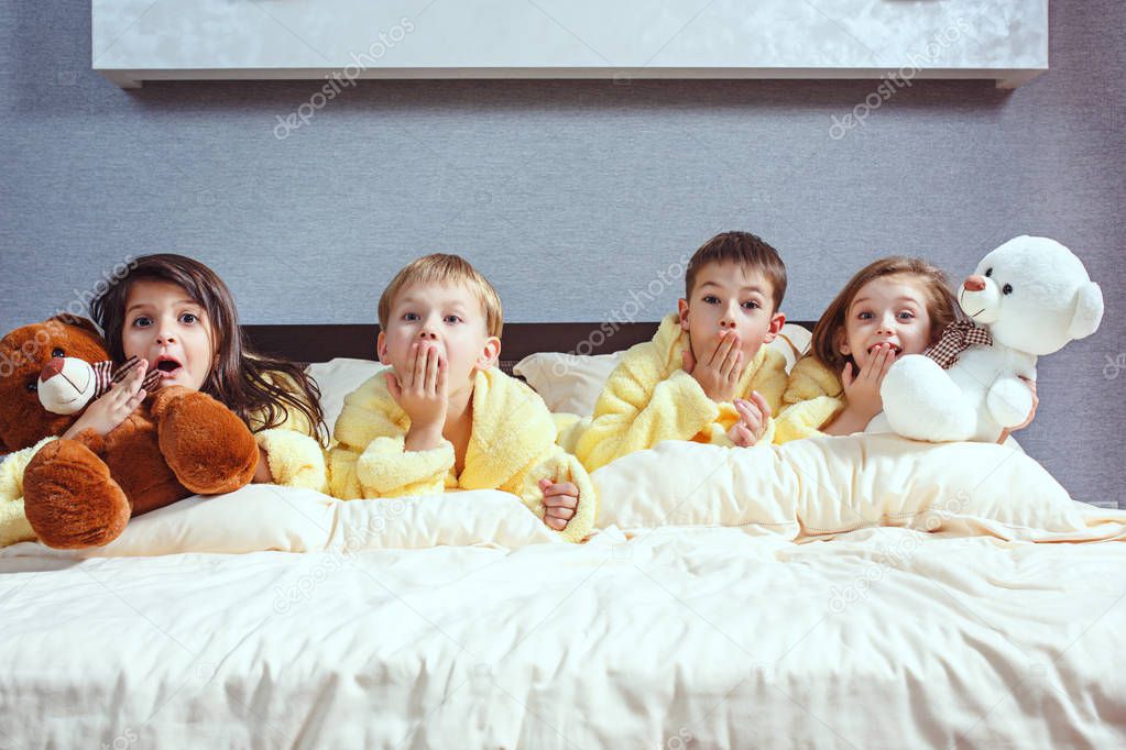 The group of friends taking goog time on bed