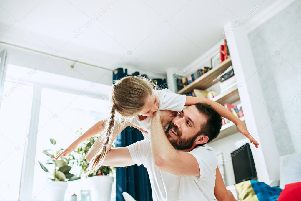 Father and his six years kid girl at home