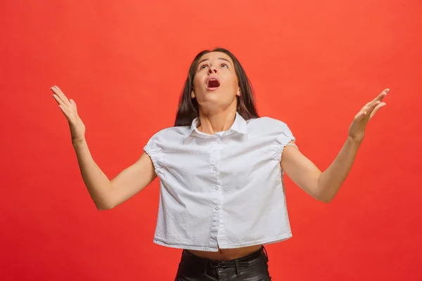 Wunderschönes Frauenporträt, isoliert auf rotem Studiohintergrund. die junge emotional überraschte Frau — Stockfoto