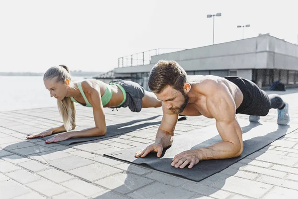 Fit Fitness Frau und Mann bei Fitnessübungen im Freien in der Stadt — Stockfoto