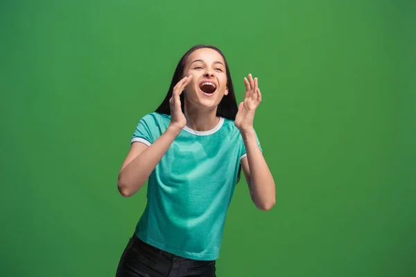 Isolated on pink young casual woman shouting at studio — Stock Photo, Image