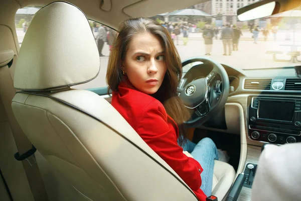 Stock image Driving around city. Young attractive woman driving a car