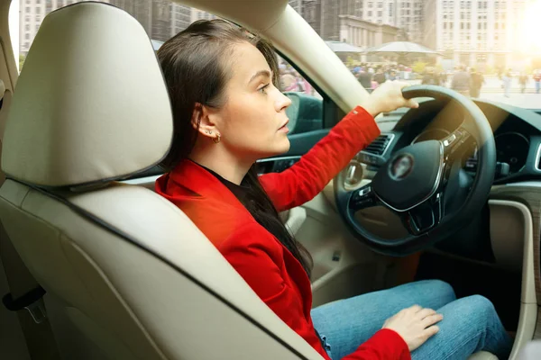 A conduzir pela cidade. Jovem mulher atraente dirigindo um carro — Fotografia de Stock