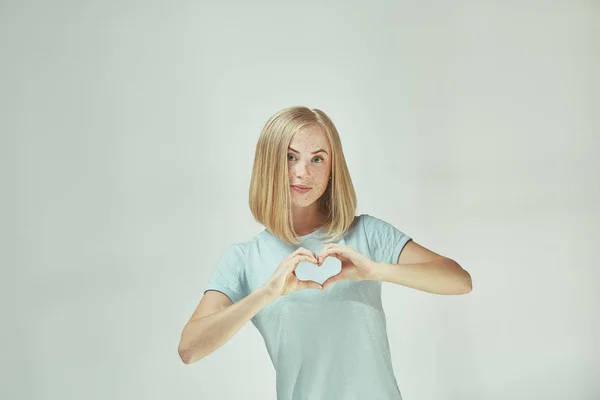 Portrait of attractive cute girl with kiss isolated over gray background — Stock Photo, Image