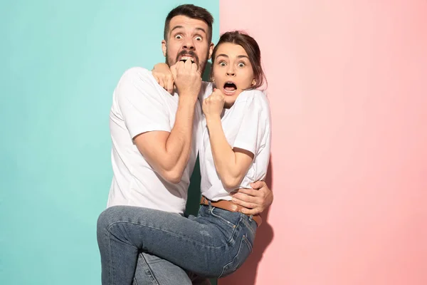 Portrait of the scared man and woman on pink and blue — Stock Photo, Image