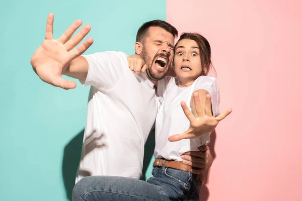 Portrait of the scared man and woman on pink and blue — Stock Photo, Image