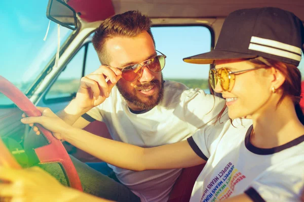 Rindo casal romântico sentado no carro, enquanto fora em uma viagem de carro no dia de verão — Fotografia de Stock