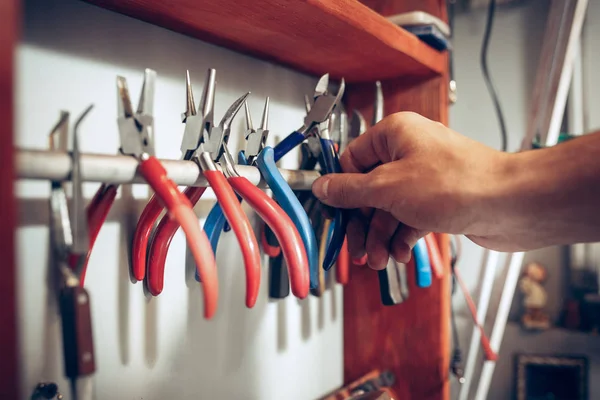 Different goldsmiths tools on the jewelry workplace. work in jewelry.