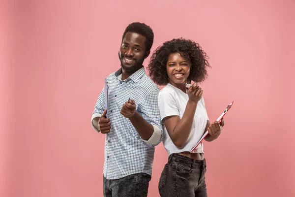 Deux étudiants africains avec des dossiers en t-shirts ensemble. Fille élégante avec coiffure afro et son petit ami . — Photo