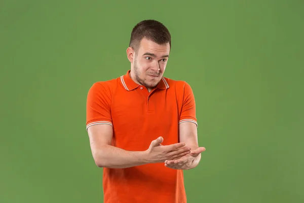 Beautiful male half-length portrait isolated on green studio backgroud. The young emotional surprised man — Stock Photo, Image