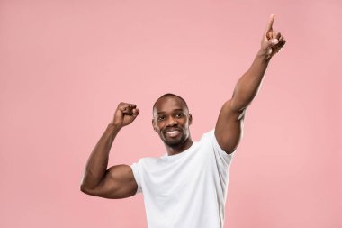 Ben kazandım. Bir kazanan olmak kutluyor kazanan başarı mutlu bir adam. Afro erkek model Pembe studio arka plan üzerinde dinamik görüntü. Zafer, zevk kavramı. İnsan yüz duyguları kavramı. Trendy renkler