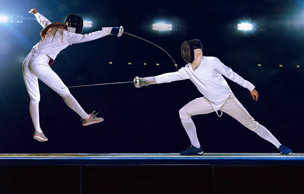 Two fencing athletes fight on professional sports arena — Stock Photo, Image