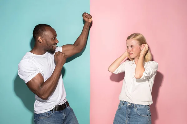 Vi vann. Vinnande framgång lycklig afro man och kvinna som firar att vara en vinnare. Dynamisk bild av kaukasiska kvinnliga och manliga modell på rosa studio. — Stockfoto