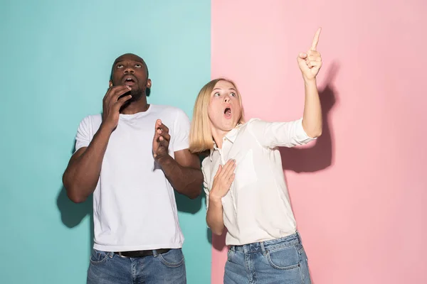 Portrait of the scared man and woman on pink and blue — Stock Photo, Image