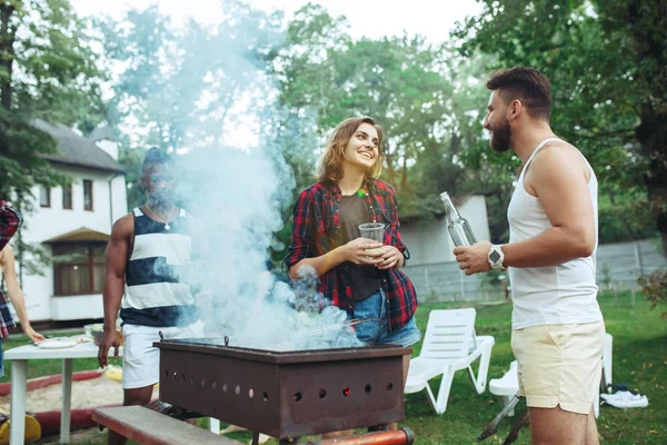 Group of friends making barbecue in the backyard. concept about good and positive mood with friends