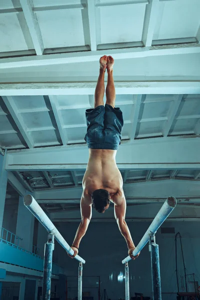 El deportista durante el ejercicio difícil, la gimnasia deportiva — Foto de Stock