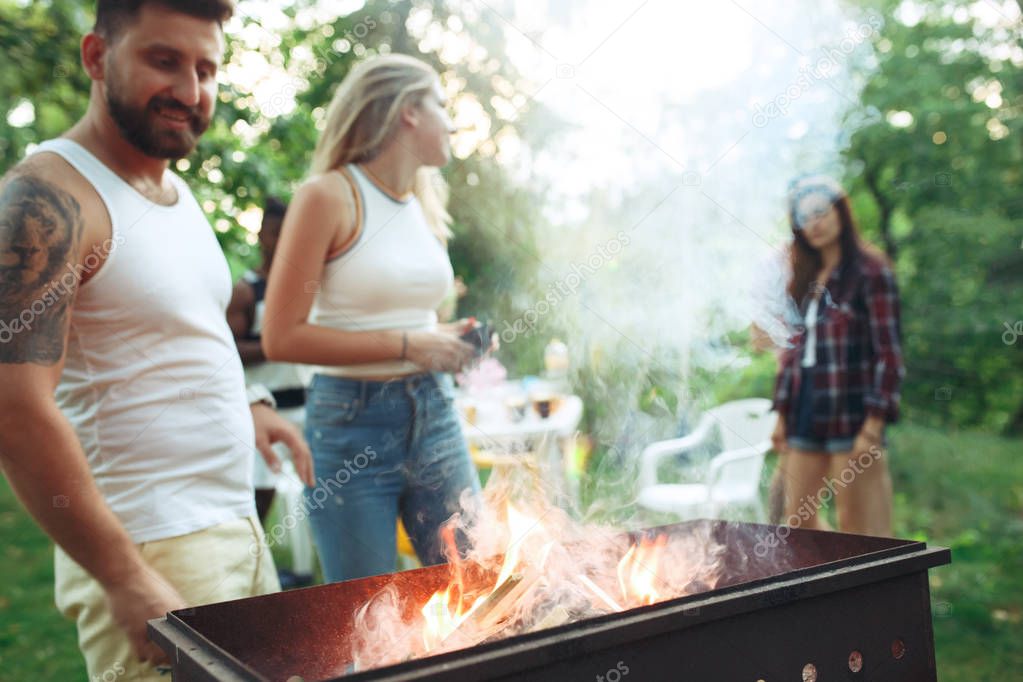 Group of friends making barbecue in the backyard. concept about good and positive mood with friends