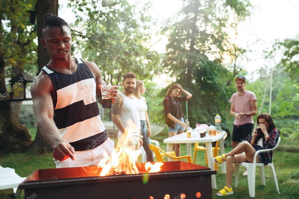 Group of friends making barbecue in the backyard. concept about good and positive mood with friends