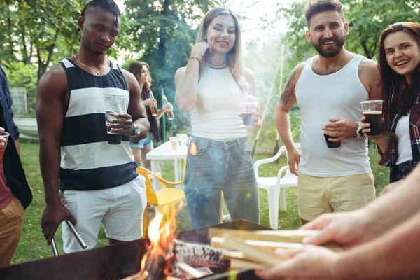 Grupo de amigos haciendo barbacoa en el patio trasero. concepto sobre el buen humor y positivo con los amigos — Foto de Stock