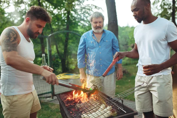 Gruppe von Freunden macht Grillen im Hinterhof. Konzept über gute und positive Stimmung mit Freunden — Stockfoto