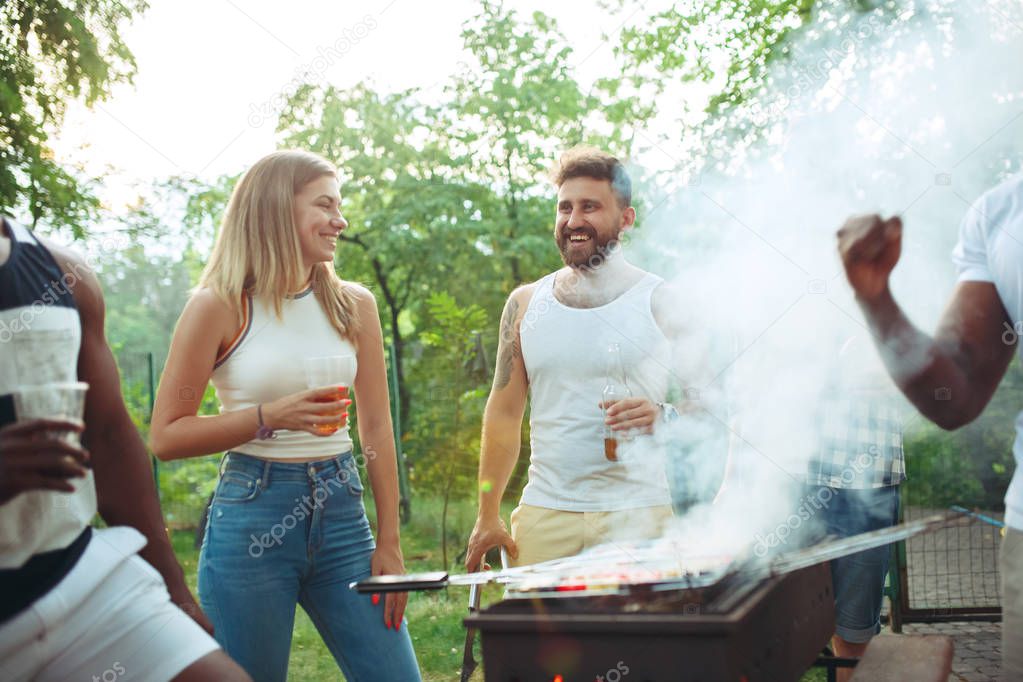 Group of friends making barbecue in the backyard. concept about good and positive mood with friends