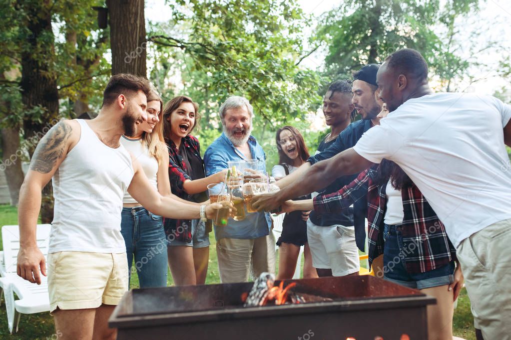 Group of friends making barbecue in the backyard. concept about good and positive mood with friends