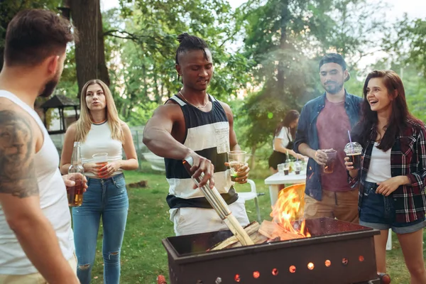 Group of friends making barbecue in the backyard. concept about good and positive mood with friends