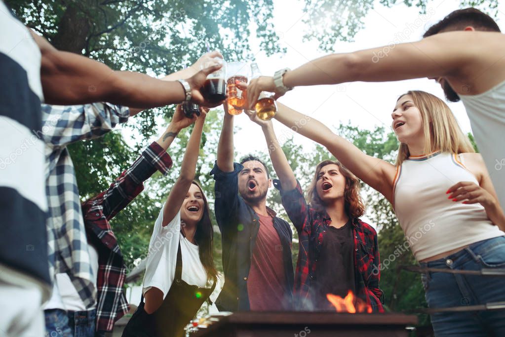 Group of friends making barbecue in the backyard. concept about good and positive mood with friends