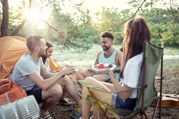 Party, camping of men and women group at forest. They relaxing and eating barbecue — Stock Photo, Image