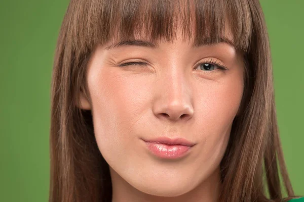 Portret van een mooie jonge vrouw winking close-up — Stockfoto
