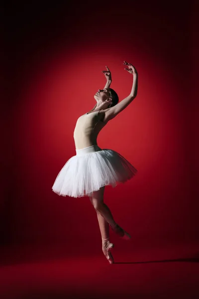 Ballerina. Young graceful female ballet dancer dancing at red studioskill. Beauty of classic ballet. — Stock Photo, Image