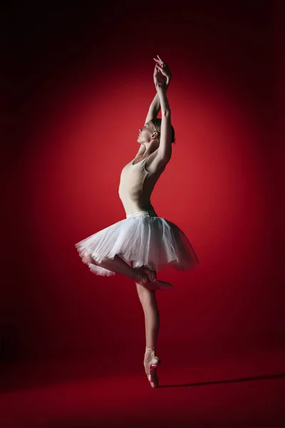 Ballerina. Young graceful female ballet dancer dancing at red studioskill. Beauty of classic ballet. — Stock Photo, Image