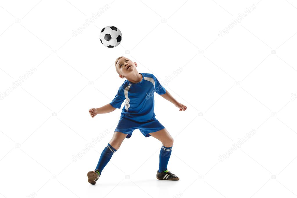 Young boy with soccer ball doing flying kick