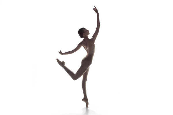 Ballerina. Young graceful female ballet dancer dancing isolated on white. Beauty of classic ballet.