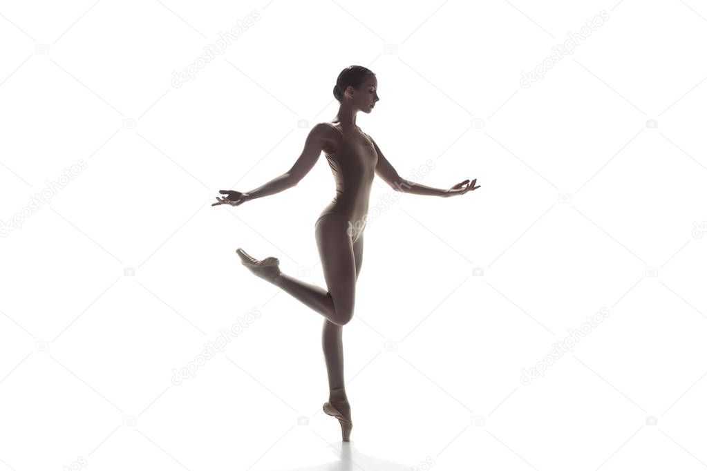 Ballerina. Young graceful female ballet dancer dancing isolated on white. Beauty of classic ballet.