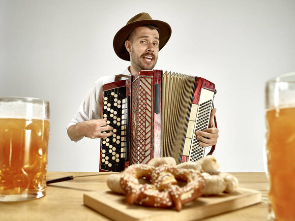 Man in traditional bavarian clothes playing accordion. Oktoberfest