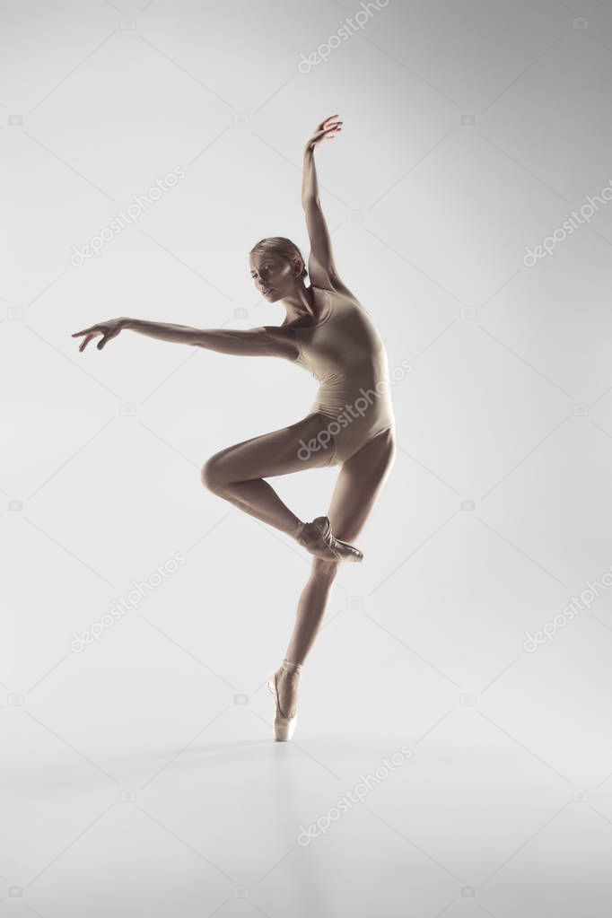 Ballerina. Young graceful female ballet dancer dancing at studio. Beauty of classic ballet.