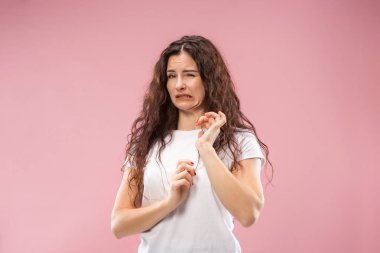 Young woman with disgusted expression repulsing something, isolated on the pink clipart