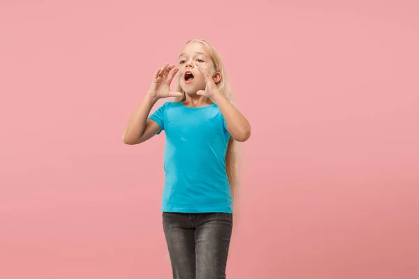 Isolated on pink young casual teen girl shouting at studio — Stock Photo, Image