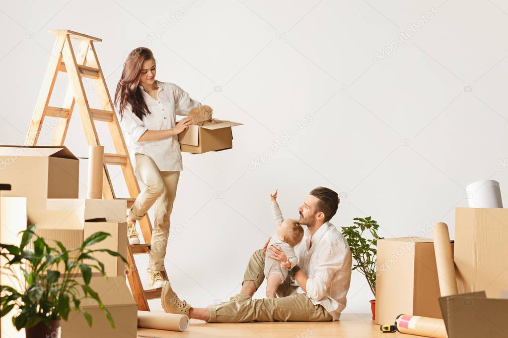 Couple moving to a new home - Happy married people buy a new apartment to start new life together