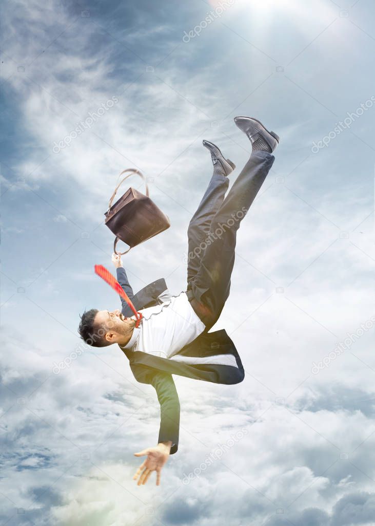 frightened businessman falling down and screaming