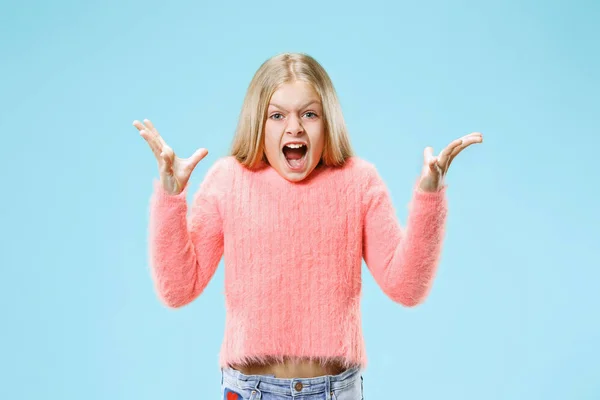 Isolated on pink young casual teen girl shouting at studio — Stock Photo, Image