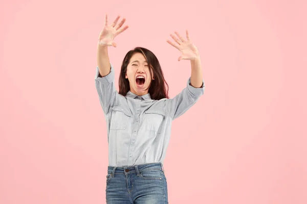 Portrait of the scared woman on pink