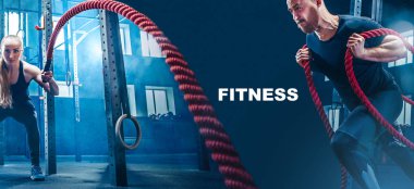 Men with battle rope battle ropes exercise in the fitness gym. clipart
