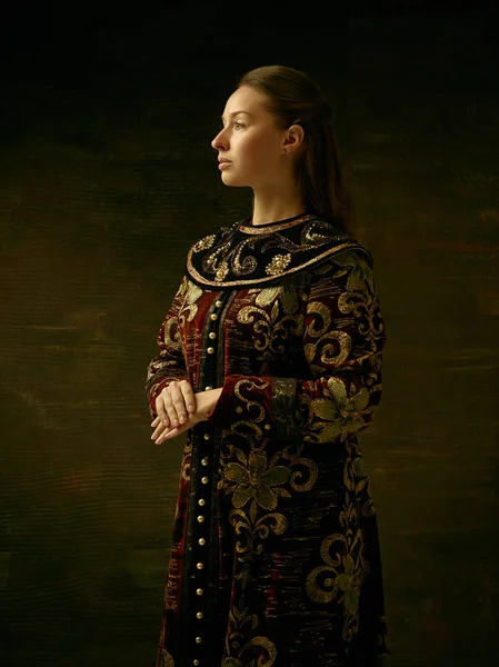 Girl standing in Russian traditional costume.