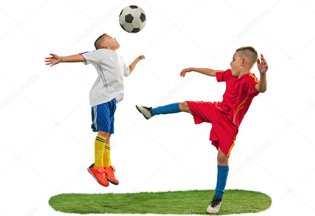 Young boys with soccer ball doing flying kick